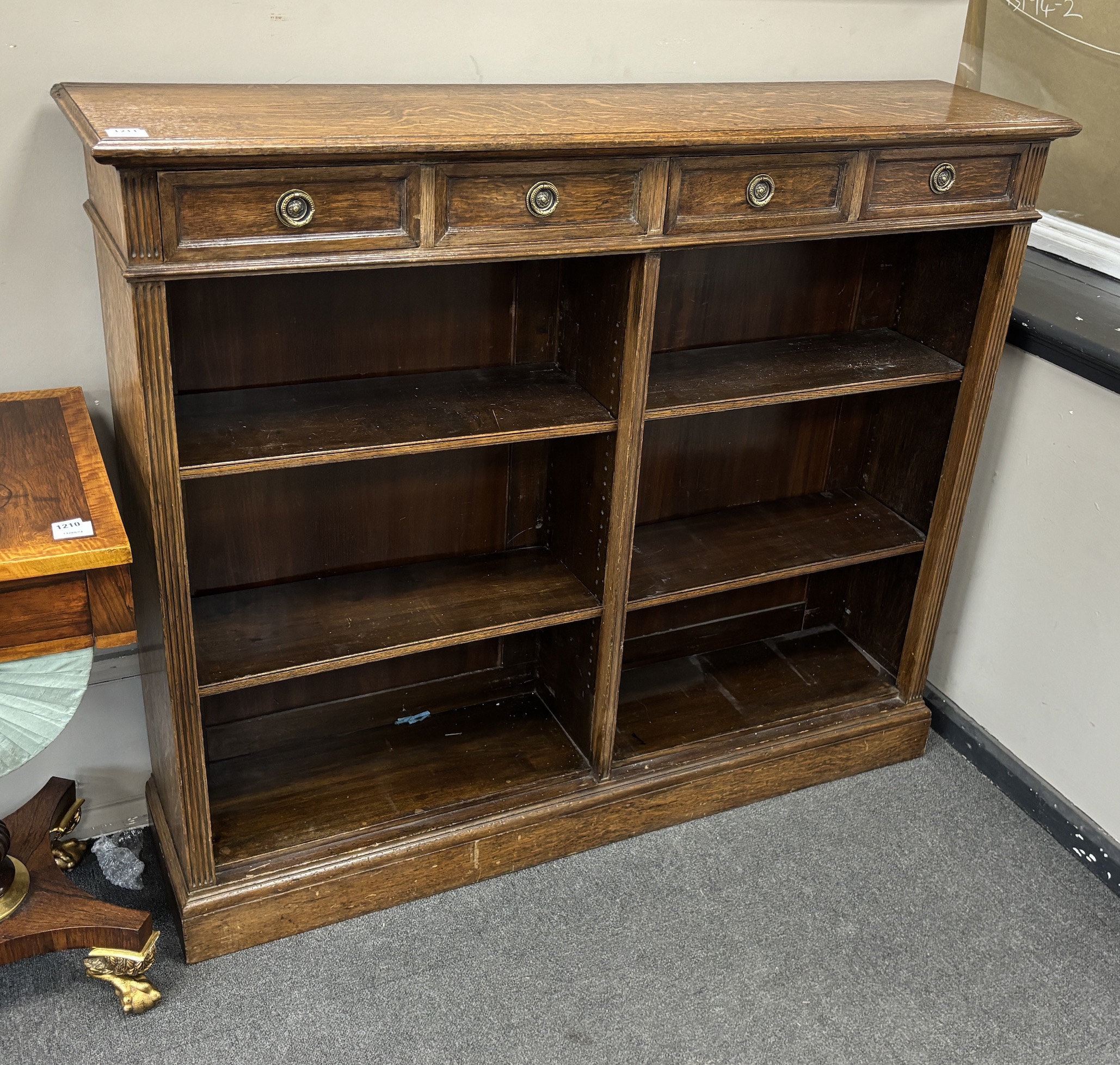 An early 20th century oak open bookcase, width 142cm, depth 33cm, height 121cm